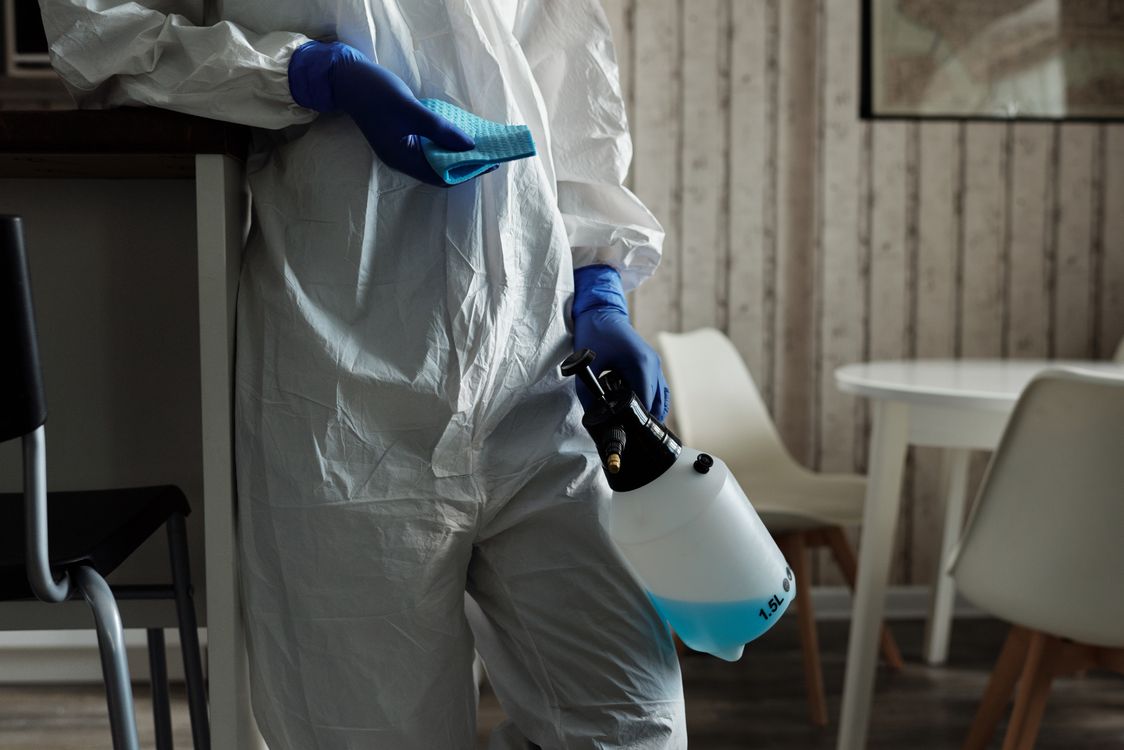 Biohazard cleaning professional in PPE working in a Maidenhead property